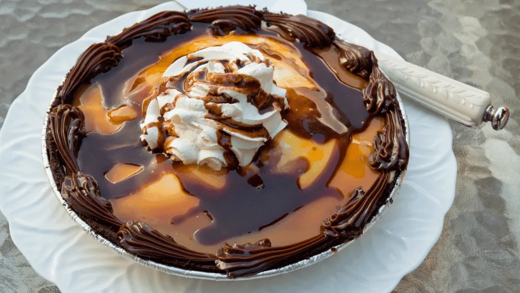A container of homemade turtle ice cream being stored in a freezer.