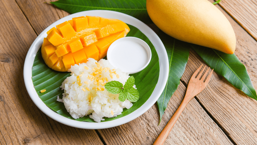 Coconut Mango Sticky Rice garnished with mung beans