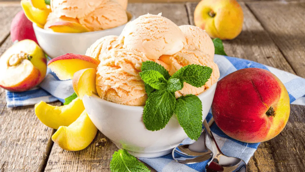 A stainless steel bowl sits on a white marble countertop, filled with a smooth, creamy base mixture. Soft light illuminates the scene, creating a serene and inviting atmosphere. Nearby, a whisk and a spatula rest, hinting at the meticulous preparation. The camera captures the moment just before the mixture is transferred to the ice cream maker, the anticipation of creating a delightful homemade treat palpable. A sense of calm professionalism pervades the image, reflecting the "Best Practices Before Freezing Ice Cream" section of the article. Best Practices Before Freezing Ice Cream