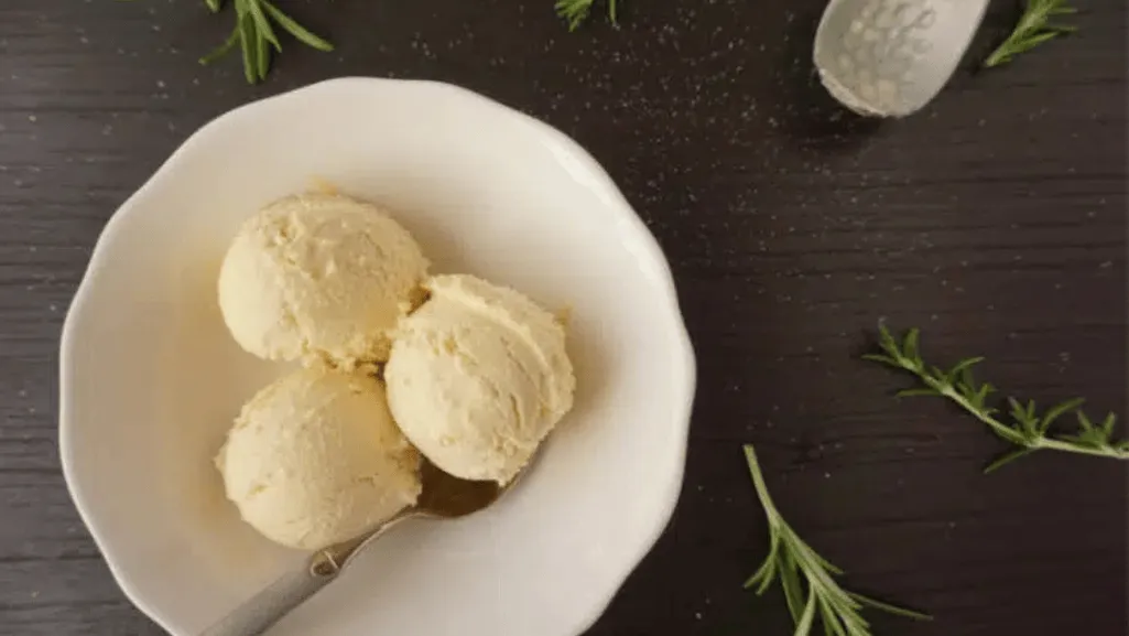 A professional-grade ice cream maker set on a stainless steel countertop, backlit by soft, warm lighting that casts a gentle glow. The machine's sleek, brushed metal exterior gleams, with a transparent lid revealing the churning mechanism within. The cylindrical canister is surrounded by an insulated housing, ready to transform fresh ingredients into velvety-smooth ice cream. The overall scene conveys a sense of precision, efficiency, and the promise of delicious homemade treats. Factors Affecting Freeze Time