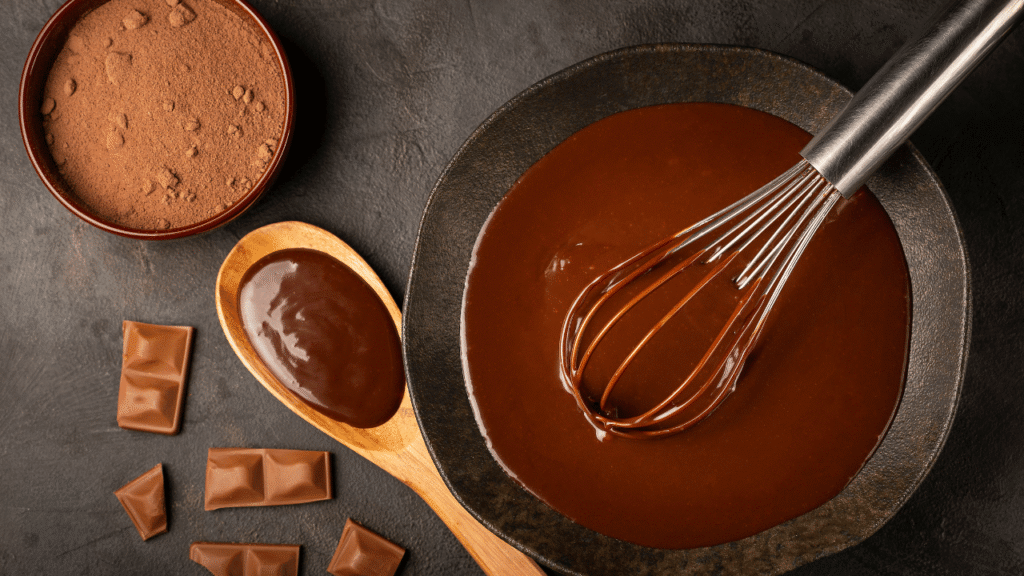A neatly arranged table showcasing a variety of ingredients for a homemade dark corn syrup ice cream recipe. In the foreground, a glass bowl filled with dark corn syrup, surrounded by measuring spoons, a whisk, and a wooden spoon. In the middle ground, various bowls containing vanilla extract, heavy cream, eggs, and sugar. In the background, a selection of flavorful add-ins such as cocoa powder, cinnamon sticks, and chopped dark chocolate. The scene is bathed in warm, golden lighting, creating a cozy and inviting atmosphere, perfect for a comforting homemade dessert.