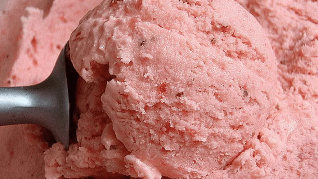 Close-up shot of ice crystals forming on a smooth, reflective surface, with a dark, moody background. The ice crystals are sharp, intricate, and delicately detailed, capturing the complexity and structure of frozen water. The lighting is soft and diffused, creating a sense of depth and dimension. The angle is slightly elevated, providing a birds-eye view of the ice formations. The overall atmosphere is contemplative, inviting the viewer to observe and appreciate the beauty of these natural, transient structures. Ice Cream Texture Troubleshooting
