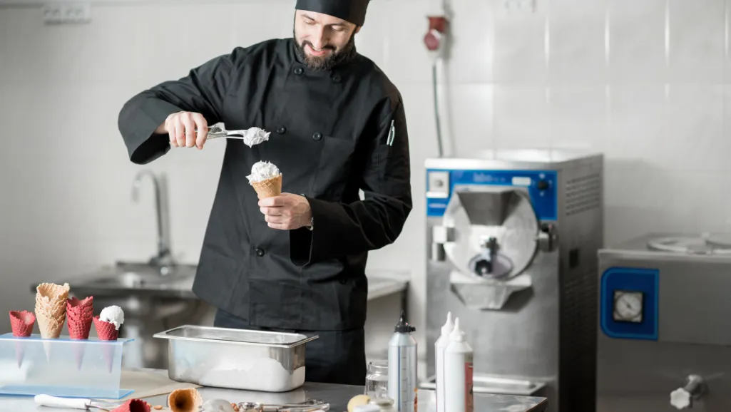 A close-up macro shot of a smooth, creamy ice cream texture with a delicate, glossy sheen. The surface appears soft and pliant, with tiny air bubbles and gentle swirls that give it a luxurious, velvety appearance. The lighting is soft and diffused, creating subtle highlights and shadows that accentuate the intricate details of the ice cream's structure. The depth of field is shallow, placing the focus squarely on the captivating texture and lush, inviting quality of the frozen treat. The overall mood is one of indulgence, temptation, and the promise of a delightful, refreshing experience.