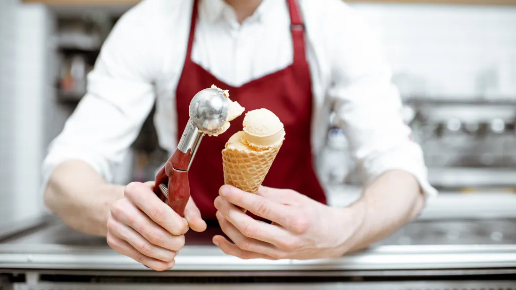 A close-up macro shot of a smooth, creamy ice cream texture, capturing the intricate patterns and swirls on the surface. The lighting is soft and diffused, creating a warm, inviting atmosphere that showcases the rich, velvety consistency of the ice cream. The image is framed in a way that emphasizes the tactile and sensory experience of the ice cream, with a focus on the subtle variations in color and sheen that give it a premium, artisanal quality. The overall mood is one of indulgence and delight, perfectly suited to highlighting the unique flavors and high-quality ingredients that make a great ice cream brand.