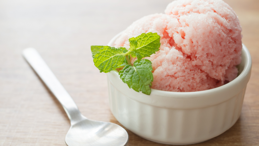 A sharply focused, high-resolution image of a clean, minimalist "Nutrition Facts" label for a "No Sugar Sherbet" product. The label is centered in the frame, with a soft, blurred background that suggests a pastel-colored, subtly textured paper or cardstock surface. The text on the label is crisp and legible, highlighting the key nutritional information such as calories, total carbohydrates, and absence of sugar. The overall mood is one of simplicity, health, and refreshment, in keeping with the article's subject matter.