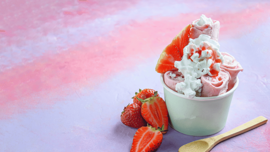A luscious strawberry sherbet, its vibrant pink hue shimmering under warm, golden lighting. In the foreground, a smooth, creamy scoop rests in a delicate glass dish, garnished with a fresh strawberry slice and a sprig of mint. The middle ground showcases a metal ice cream scoop and a bowl of juicy, ruby-red strawberries, hinting at the simple, homemade ingredients. In the background, a crisp, white backdrop suggests a clean, modern kitchen setting. The overall atmosphere is one of refreshing indulgence, inviting the viewer to savor the cool, tangy sweetness of this delightful summer treat. Tips for the Best Strawberry Sherbet Recipe