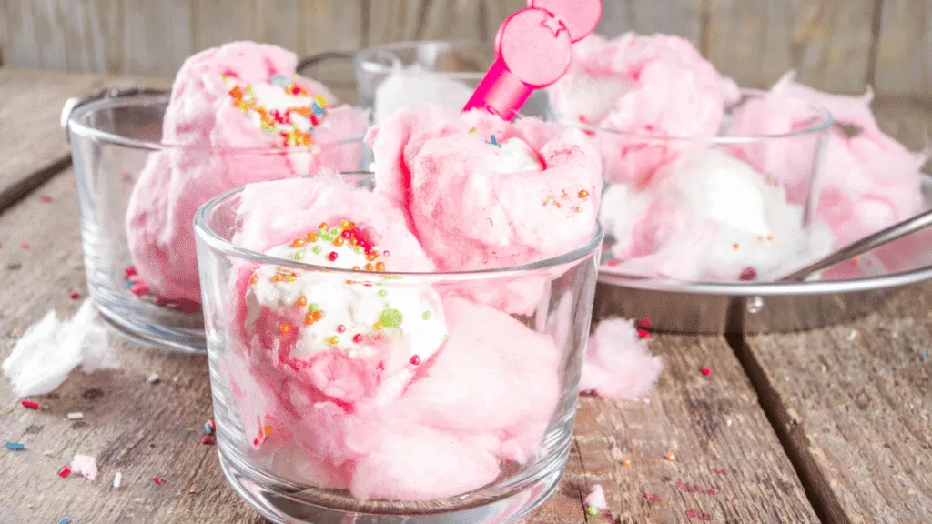 A vibrant still life, bathed in warm, golden lighting and captured with a soft, dreamy lens. In the foreground, an assortment of essential ice cream ingredients stands out in sharp focus - plump, ripe strawberries, rich vanilla beans, and crystalline sugar cubes. In the middle ground, a collection of shiny metal scoops and a vintage-inspired ice cream scoop nestle among the ingredients, hinting at the delicious dessert to come. The background is hazy and atmospheric, with a faint, pastel-hued swirl that suggests the creamy, swirling texture of the final frozen treat. The overall mood is one of anticipation and indulgence, inviting the viewer to imagine the delightful, sweet sensations of homemade cotton candy ice cream. Cotton Candy Ice Cream Gathering the Essential Ingredients