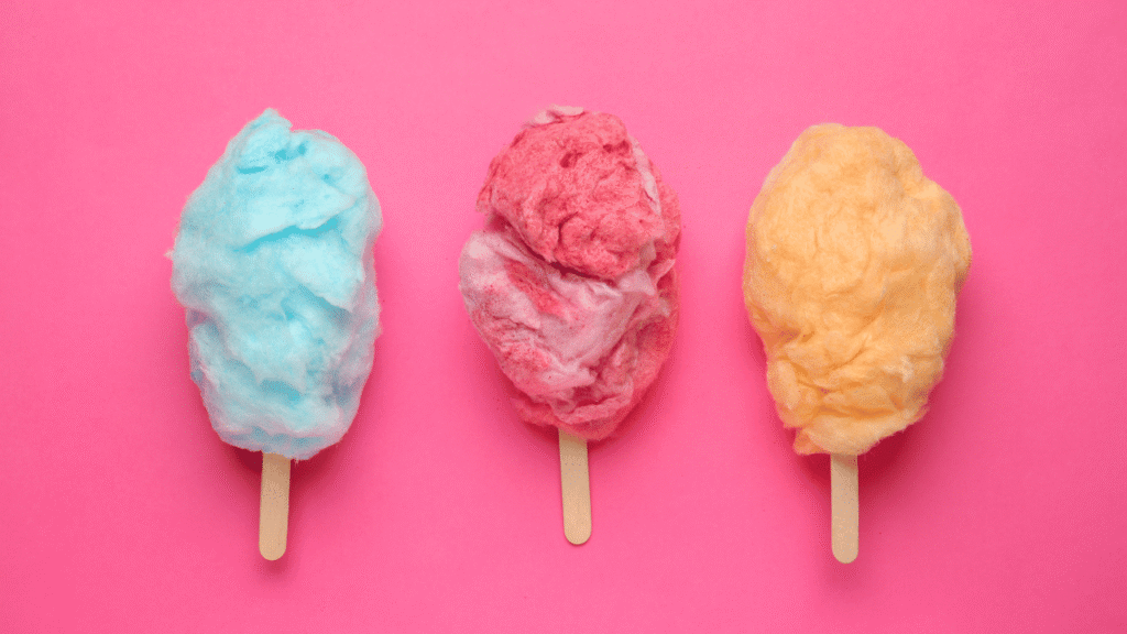 A professional, high-quality photograph of two adjacent ice cream scoops, one made with a traditional churning method and the other with a no-churn technique. The traditional scoop has a dense, creamy texture and a smooth, glossy appearance, while the no-churn scoop has a lighter, airier structure and a slightly more granular surface. The scoops are set against a clean, minimalist background, with soft, even lighting that accentuates the intricate textures and subtle color differences between the two ice cream preparations. The overall composition is balanced and visually striking, inviting the viewer to closely examine the contrasting techniques and their impact on the final product. No-Churn Versus Traditional Cotton Candy Ice Cream Recipe Methods
