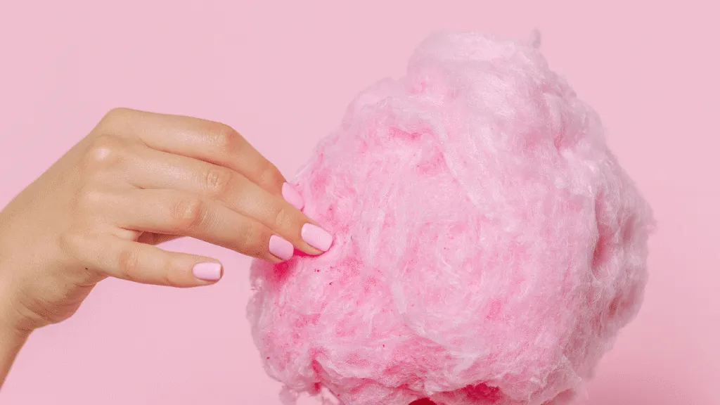 A neatly arranged counter showcasing the homemade cotton candy ice cream recipe steps. In the foreground, a stainless steel mixing bowl filled with a vibrant pink cotton candy-flavored ice cream mixture, garnished with sprinkles. Next to it, a stack of handwritten recipe cards with delicate cursive text against a soft, pastel-colored background. In the middle ground, various kitchen tools and appliances, such as an electric hand mixer, a whisk, and a measuring cup, are placed strategically. The lighting is warm and natural, creating a cozy, inviting atmosphere. The entire scene is shot from a slightly elevated angle, capturing the process of creating this delightful, whimsical dessert. Step-by-Step Recipe Guide for Homemade Cotton Candy Ice Cream