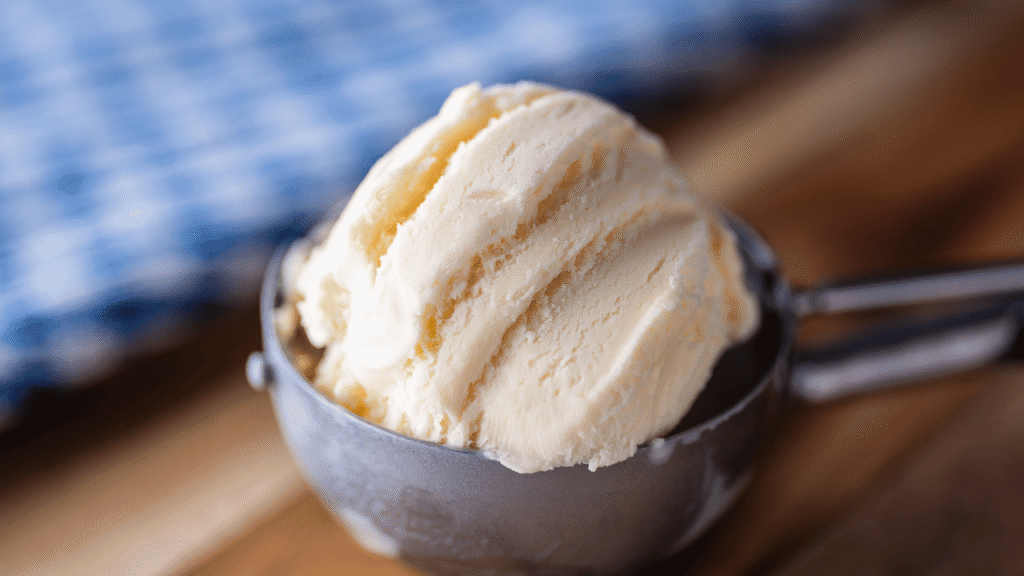 A delectable scoop of rich, creamy ice cream, swirled with vibrant flecks of red chili peppers and a dusting of cinnamon. The frozen treat glistens under a warm, soft lighting, creating a mesmerizing contrast between the cool, smooth texture and the fiery, spicy notes. In the background, a hazy, ethereal atmosphere evokes a sense of wonder and anticipation, drawing the viewer into the captivating world of unexpected and tantalizing ice cream flavors.