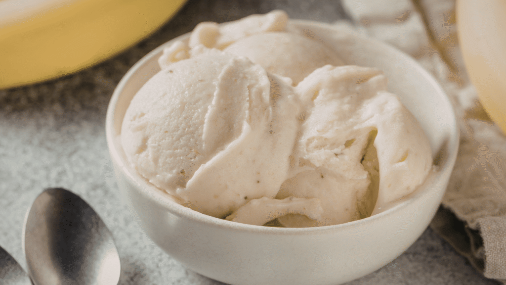 A close-up shot of an ultra-detailed, high-resolution texture inspired by pro cooking tips. The texture features a smooth, creamy background with subtle variations in shades of off-white and pale yellow, reminiscent of a freshly churned ice cream. Interspersed throughout are small, raised bumps and grooves, creating a tactile, almost three-dimensional effect. The lighting is soft and diffused, casting gentle shadows that accentuate the textural elements. The angle is slightly angled, providing a dynamic perspective that draws the viewer in. The overall mood is one of craftsmanship, quality, and the promise of a delightful culinary experience. Banana ice cream recipe Pro tips for perfect texture and flavor every time